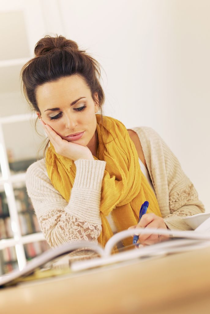 Girl in yellow scarf studying